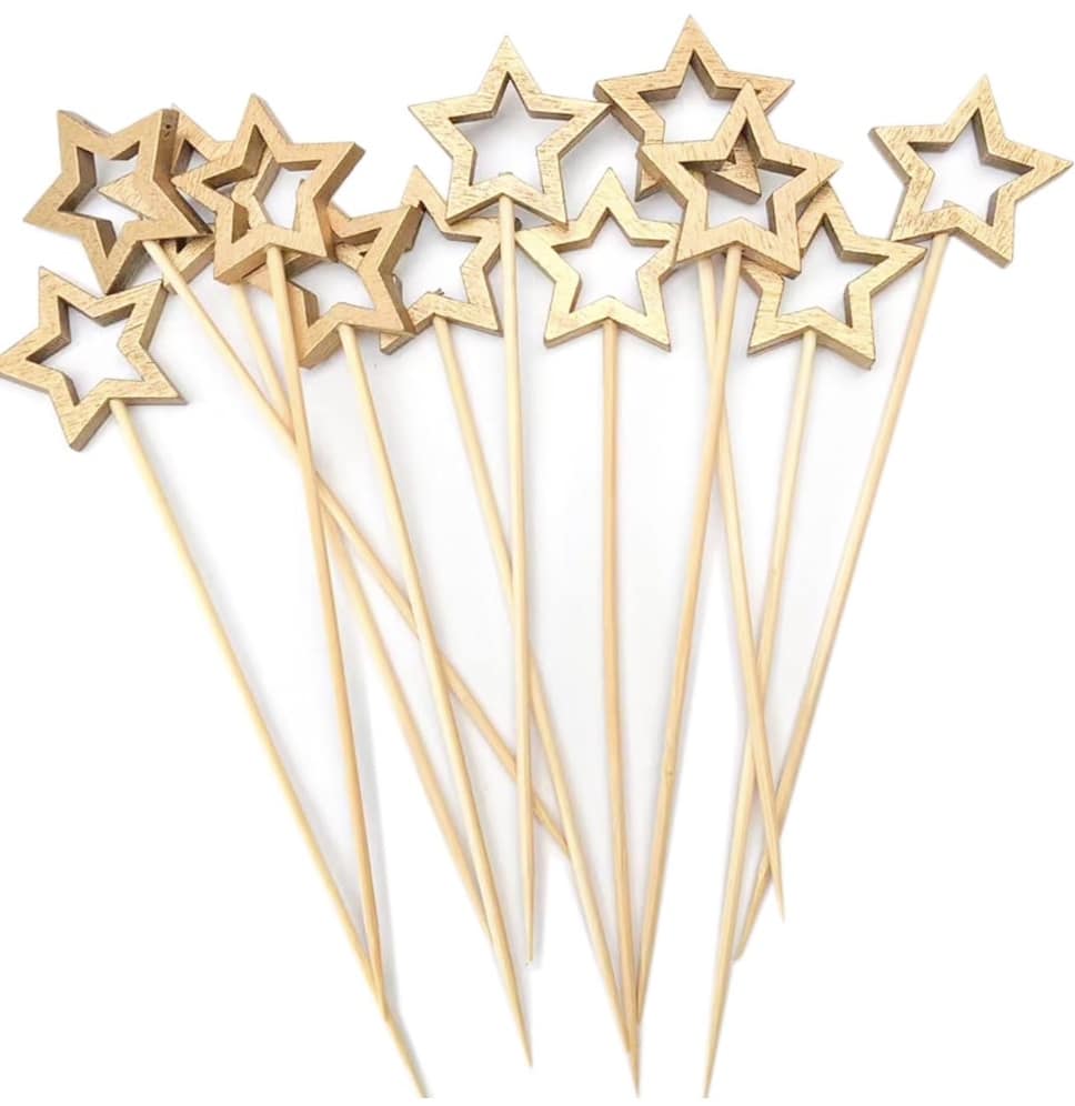 A collection of wooden skewers topped with hollow star shapes, ideal for adding a festive touch to your New Year's recipes, arranged in a scattered pattern.